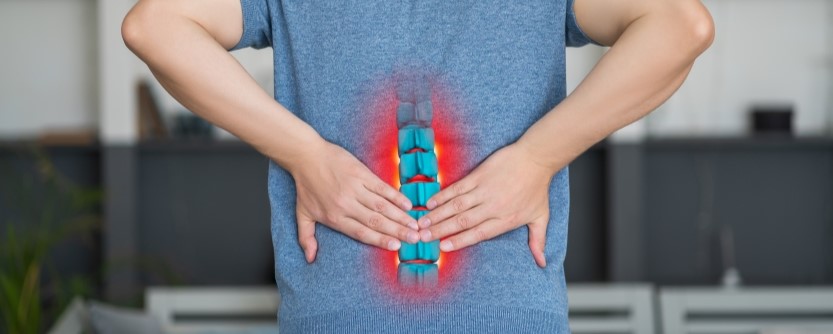 herniated disc causing lower back pain in st petersburg fl patient holding back